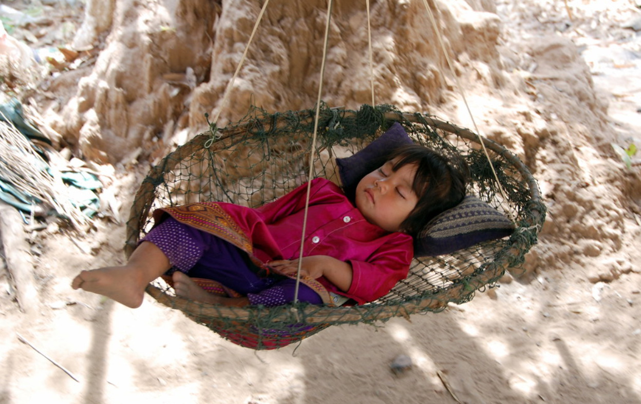 Baby asleep in a hammock.