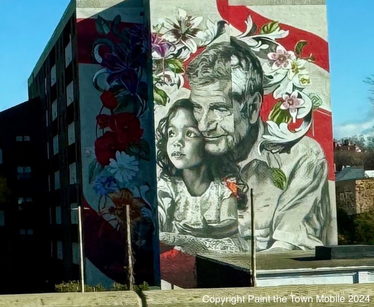 Graffiti showing a father embracing his daughter.