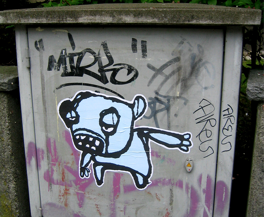 Graffiti on a wall with a distruntled looking cartoon figure