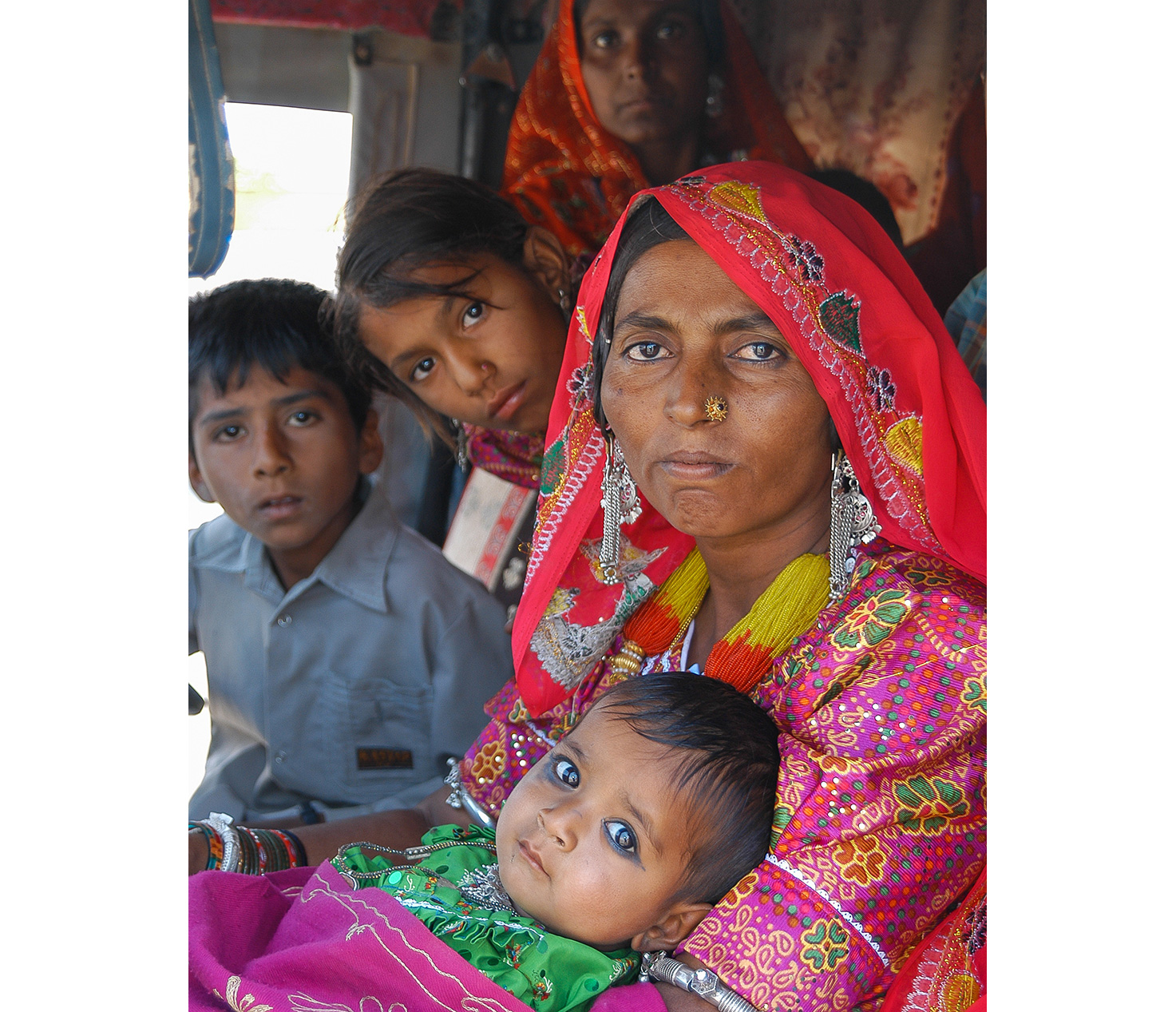 An Indian peasant woman surrounded with her kids.